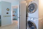 Queen guest room featuring large closet with full-size washer/dryer